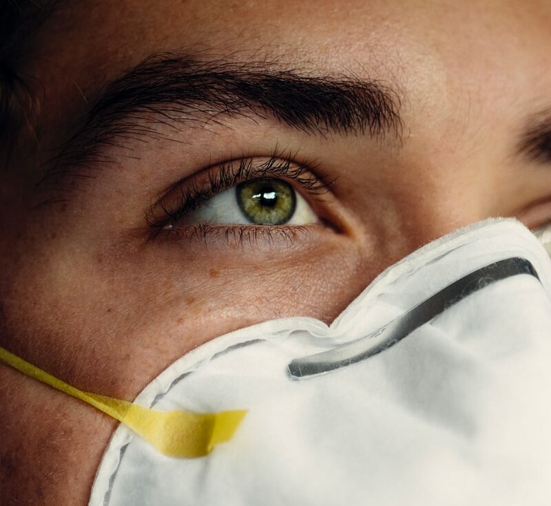 person in white face mask